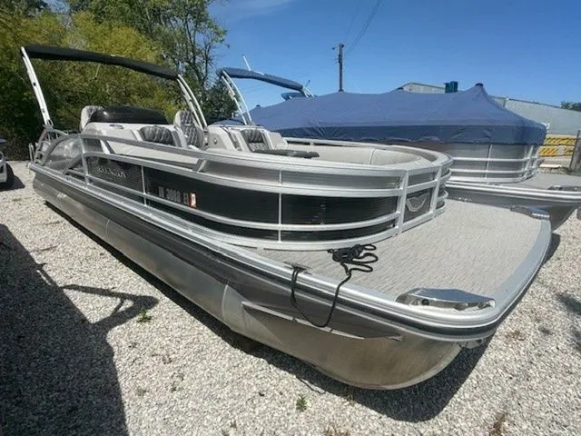 The Image of 2023 Bennington 25 RTSB pontoon boat parked on gravel surface. - 1