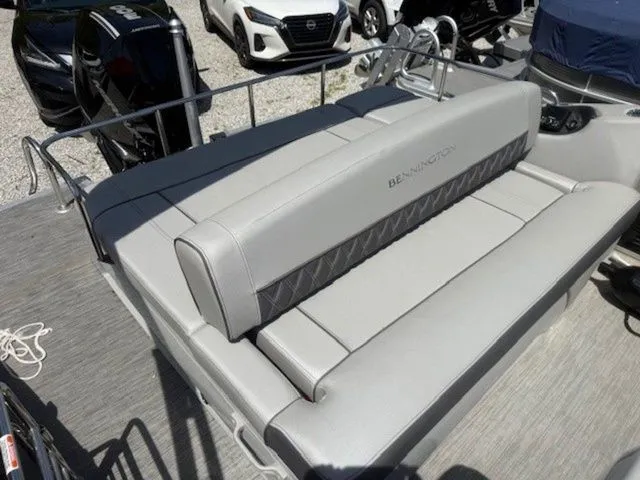 Slide: The Image of 2023 Bennington 25 RTSB boat with gray upholstery outdoors. - 10
