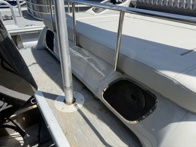 Slide: The Image of Bennington 25 RTSB 2023 boat with speakers and seating area. - 12