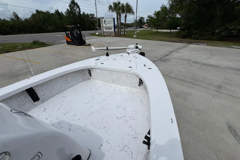 Slide: The Image of 2021 Blazer Bay 2220 GTS boat on concrete lot with trees and forklift nearby. - 15