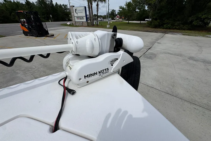 Slide: The Image of Minn Kota Ulterra motor on 2021 Blazer Bay 2220 GTS boat, parked outdoors. - 18