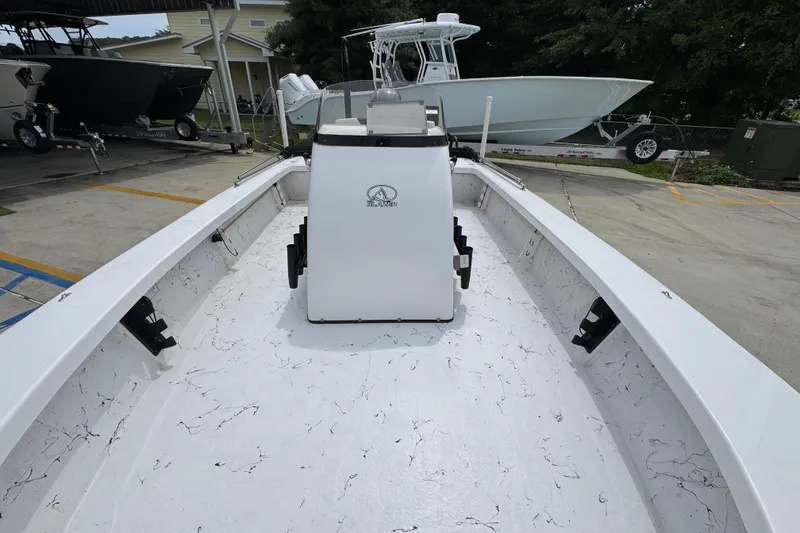 Slide: The Image of 2021 Blazer Bay 2220 GTS boat interior with white marbled deck, parked outdoors. - 21