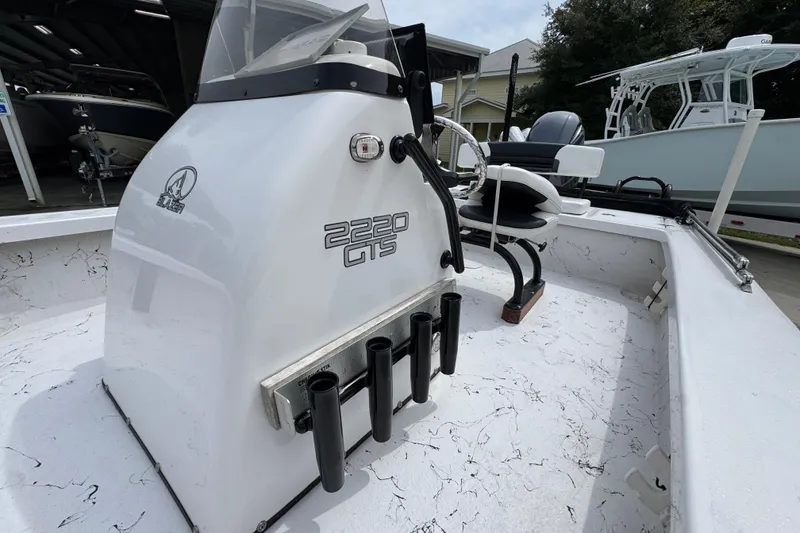 Slide: The Image of 2021 Blazer Bay 2220 GTS boat interior with console and seating, showcasing sleek design. - 22