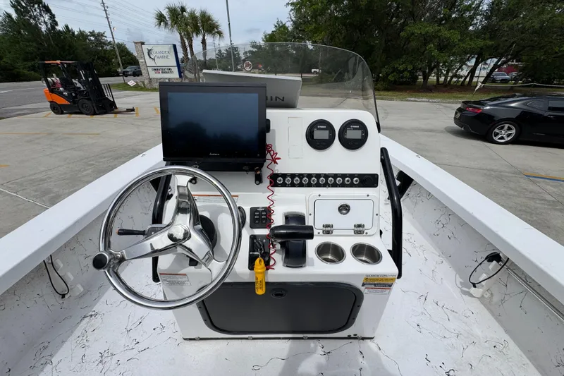 Slide: The Image of 2021 Blazer Bay 2220 GTS boat console with steering wheel, gauges, and navigation screen. - 27