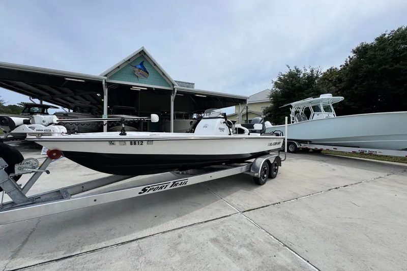 Slide: The Image of 2021 Blazer Bay 2220 GTS boat on trailer, parked outdoors near other boats. - 3