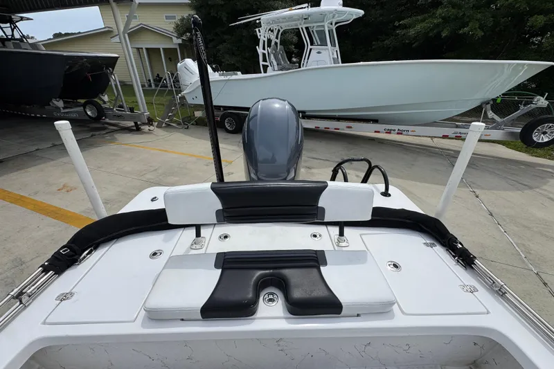 Slide: The Image of 2021 Blazer Bay 2220 GTS boat interior with motor, parked on concrete. - 30