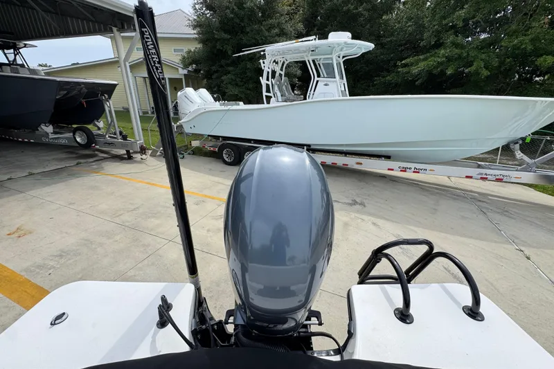 Slide: The Image of 2021 Blazer Bay 2220 GTS boat on trailer, viewed from behind, with outboard motor. - 32