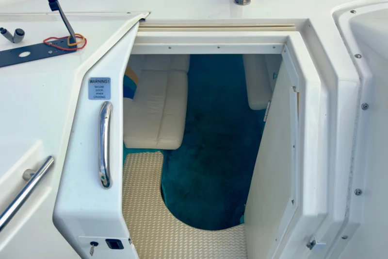 Slide: The Image of 1995 Wellcraft Scarab 31 cabin entrance with white interior and blue carpet. - 11
