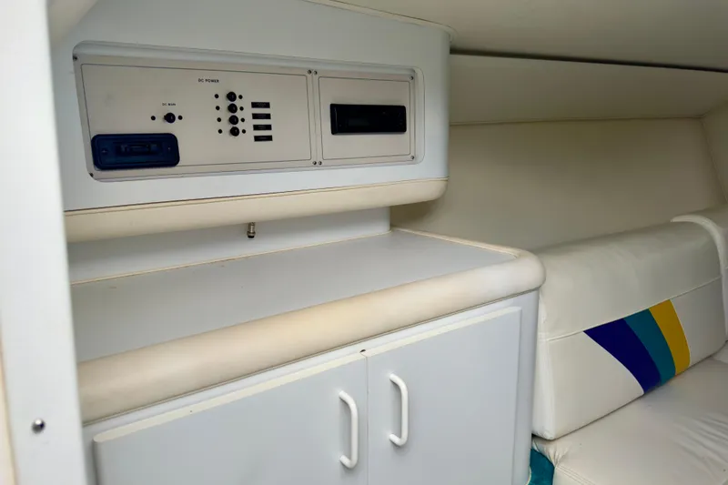Slide: The Image of 1995 Wellcraft Scarab 31 cabin interior with control panel and cushioned seating. - 13