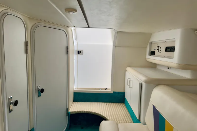 Slide: The Image of Interior of 1995 Wellcraft Scarab 31 boat, featuring white cabinetry and seating. - 15