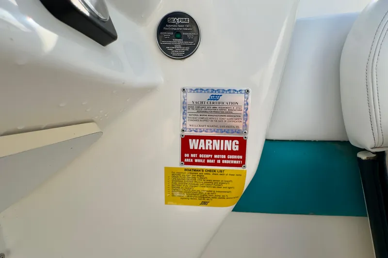 Slide: The Image of 1995 Wellcraft Scarab 31 interior with safety and certification labels. - 17