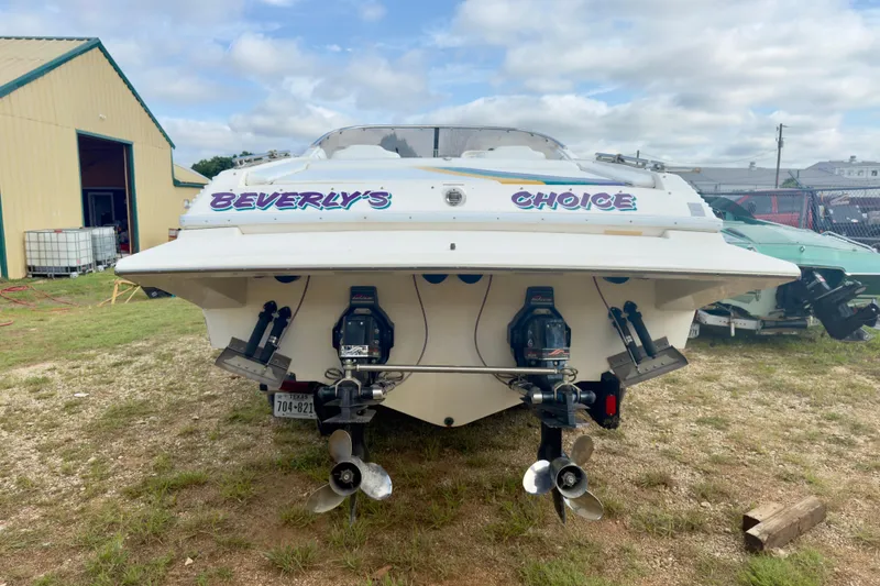 Slide: The Image of 1995 Wellcraft Scarab 31 boat, rear view, with dual engines, labeled "Beverly's Choice." - 6