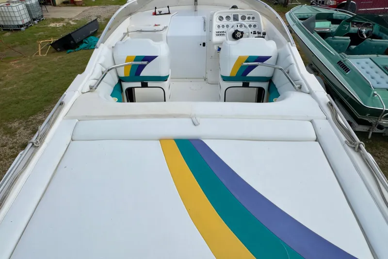 Slide: The Image of 1995 Wellcraft Scarab 31 boat interior with colorful seating and dashboard. - 7