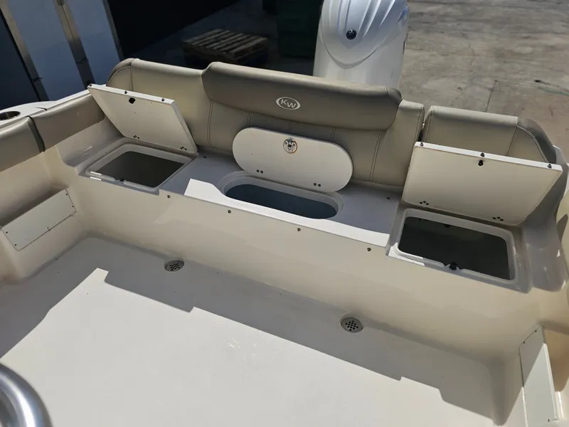 Slide: The Image of 2024 Key West 239 FS boat with storage compartments and seating area. - 23