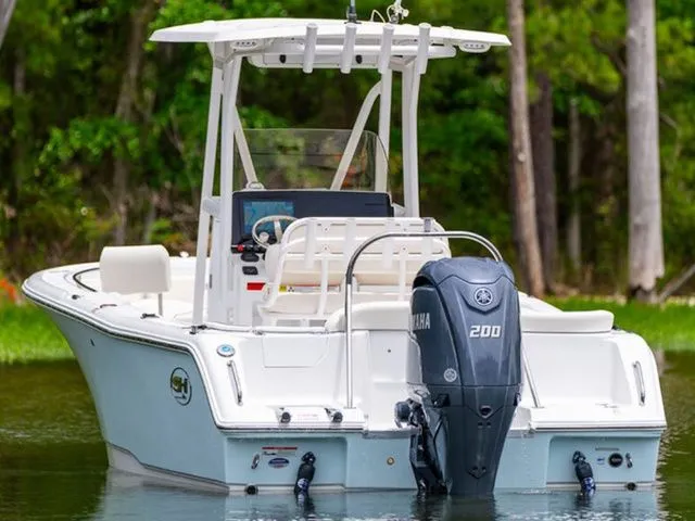 Slide: The Image of 2026 Sea Hunt Ultra 229 boat with Yamaha 200 engine on calm water. - 2