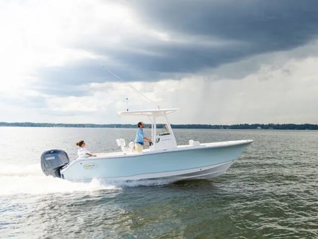 Slide: The Image of 2026 Sea Hunt Ultra 229 boat cruising on calm waters. - 4