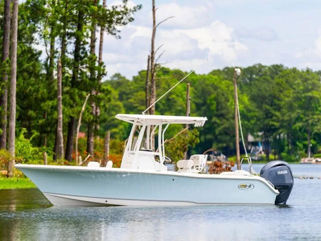 Slide: The Image of 2026 Sea Hunt Ultra 229 boat on a tranquil lake. - 7