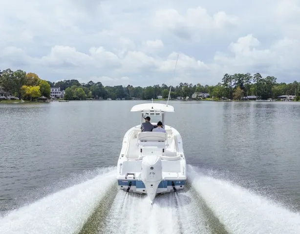 Slide: The Image of Sea Hunt Ultra 245 SE 2026 cruising on a tranquil lake. - 9