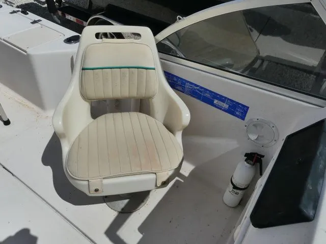 Slide: The Image of Interior of a 1998 Scout 172 Dorado boat with seat and fire extinguisher. - 11