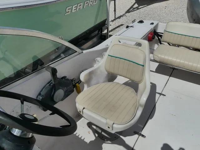 Slide: The Image of Interior of a 1998 Scout 172 Dorado boat with steering and seat. - 12