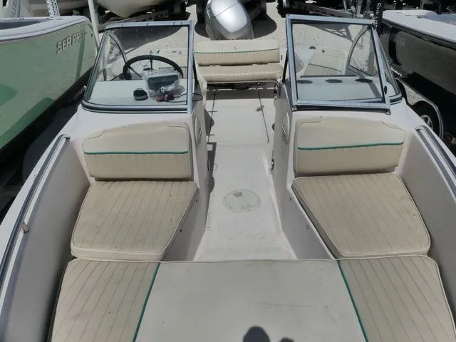 Slide: The Image of Interior view of a 1998 Scout 172 Dorado boat with beige seats. - 14