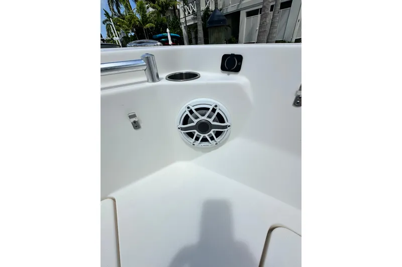 Slide: The Image of 2021 Cobia 240 Center Console boat interior with speaker and cup holder. - 13