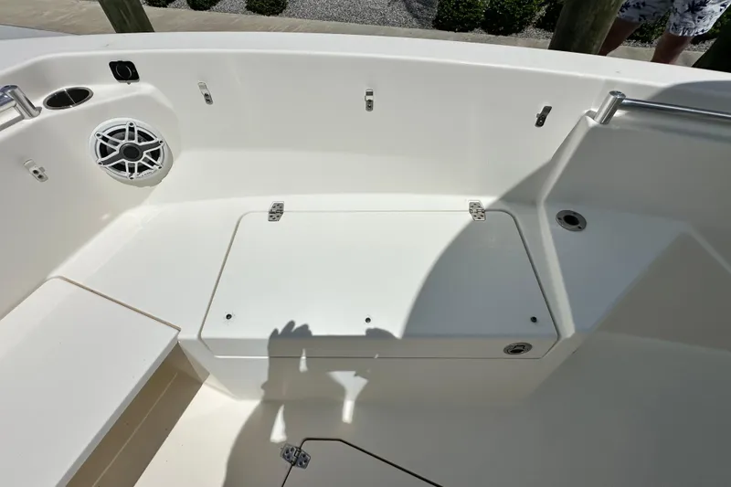 Slide: The Image of 2021 Cobia 240 Center Console boat interior with storage compartment and speaker. - 14