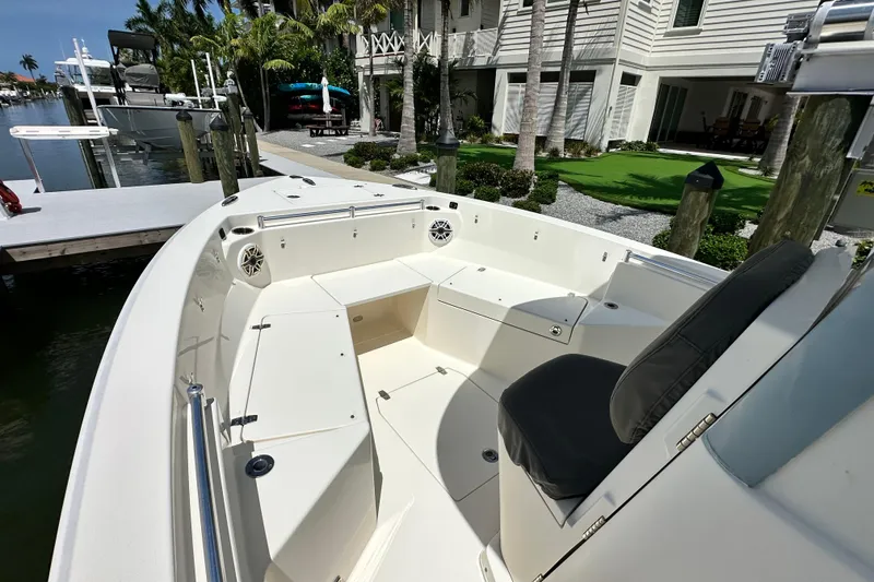 Slide: The Image of 2021 Cobia 240 Center Console boat docked near waterfront property. - 19