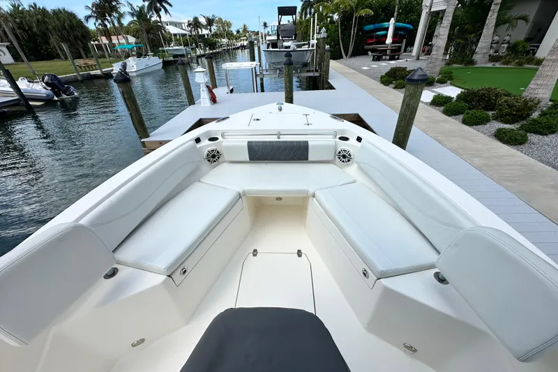 Slide: The Image of 2021 Cobia 240 Center Console boat docked, featuring spacious seating and modern design. - 21