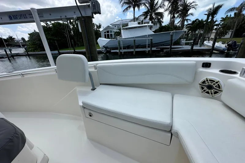 Slide: The Image of 2021 Cobia 240 Center Console boat interior with white seating and speaker. - 24