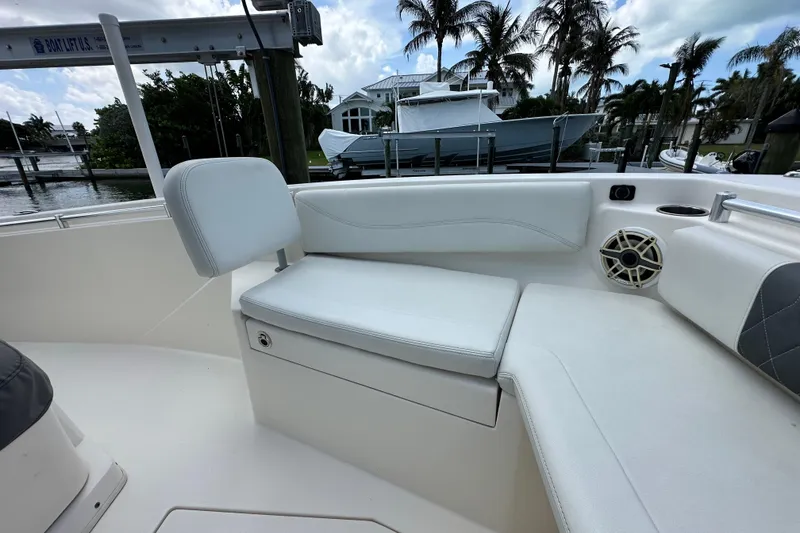 Slide: The Image of 2021 Cobia 240 Center Console boat interior with white seating and speaker. - 25
