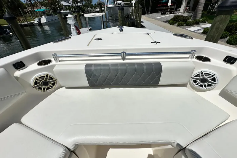 Slide: The Image of 2021 Cobia 240 Center Console boat interior with cushioned seating and speakers. - 26