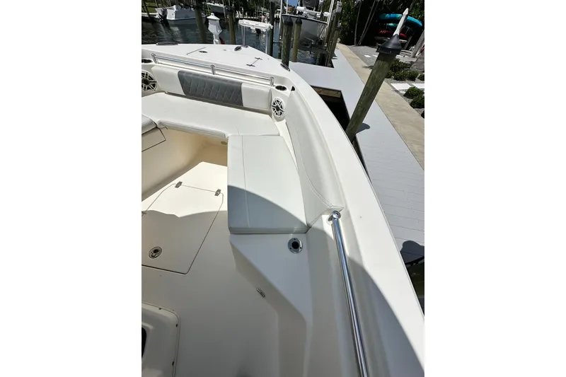 Slide: The Image of 2021 Cobia 240 Center Console boat interior with cushioned seating and storage compartments. - 27