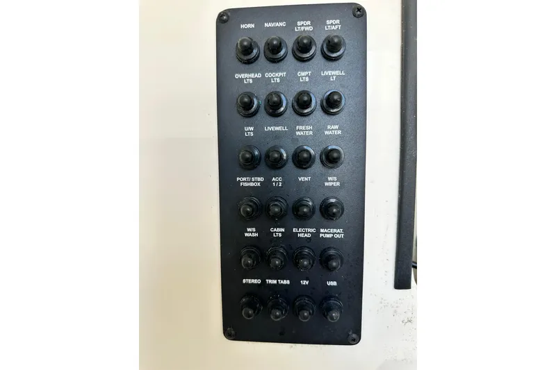 Slide: The Image of Control panel of a 2021 Cobia 240 Center Console boat with labeled switches. - 35