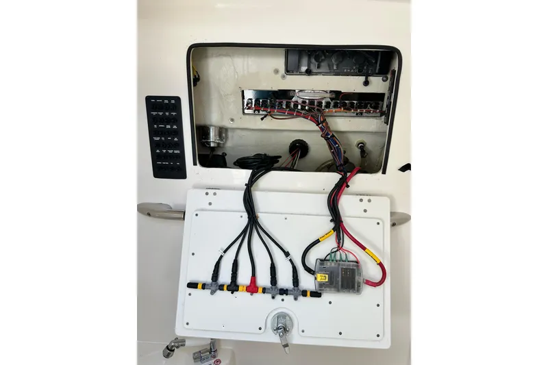 Slide: The Image of Electrical panel of 2021 Cobia 240 Center Console boat with wiring and switches. - 36