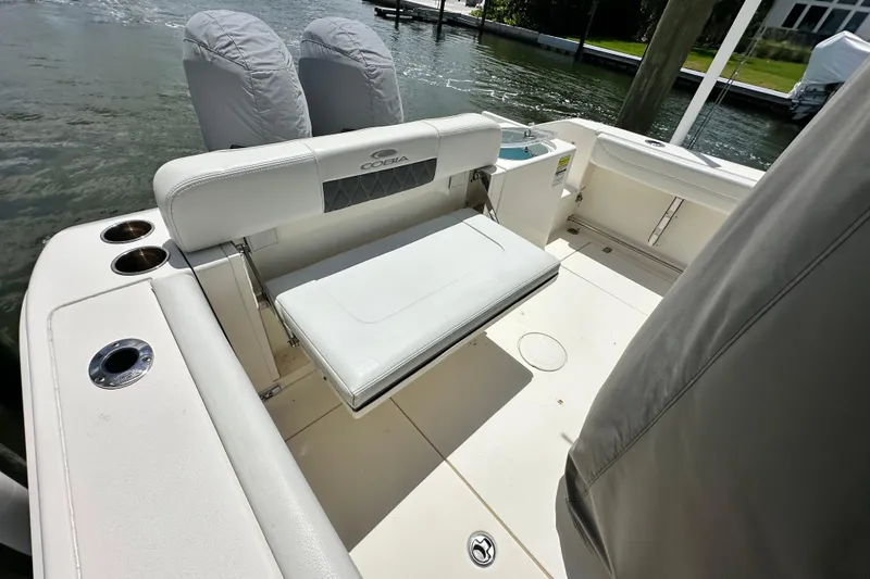 Slide: The Image of 2021 Cobia 240 Center Console boat interior with seating and cup holders. - 41