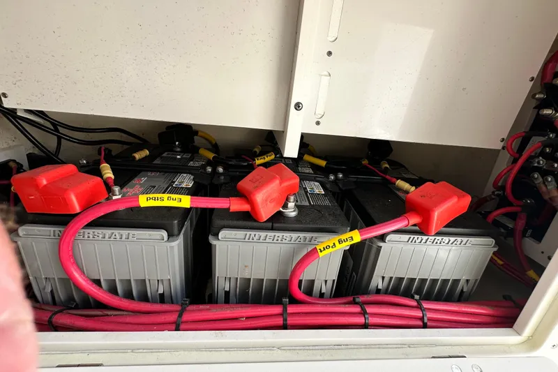 Slide: The Image of Batteries and wiring inside a 2021 Cobia 240 Center Console boat. - 58