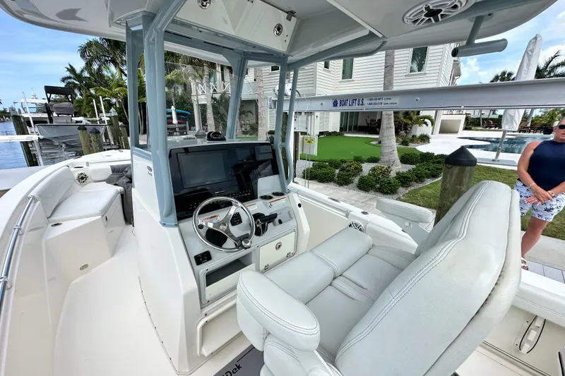 Slide: The Image of 2021 Cobia 240 Center Console boat interior with steering wheel and seating. - 61