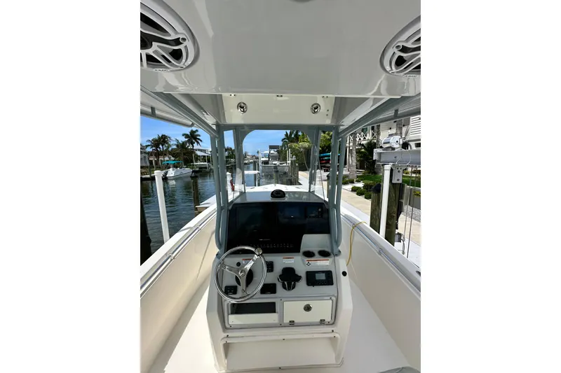 Slide: The Image of 2021 Cobia 240 Center Console boat interior with steering wheel and control panel. - 62