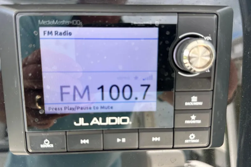 Slide: The Image of JL Audio MediaMaster display on 2021 Cobia 240 Center Console, tuned to FM 100.7. - 69