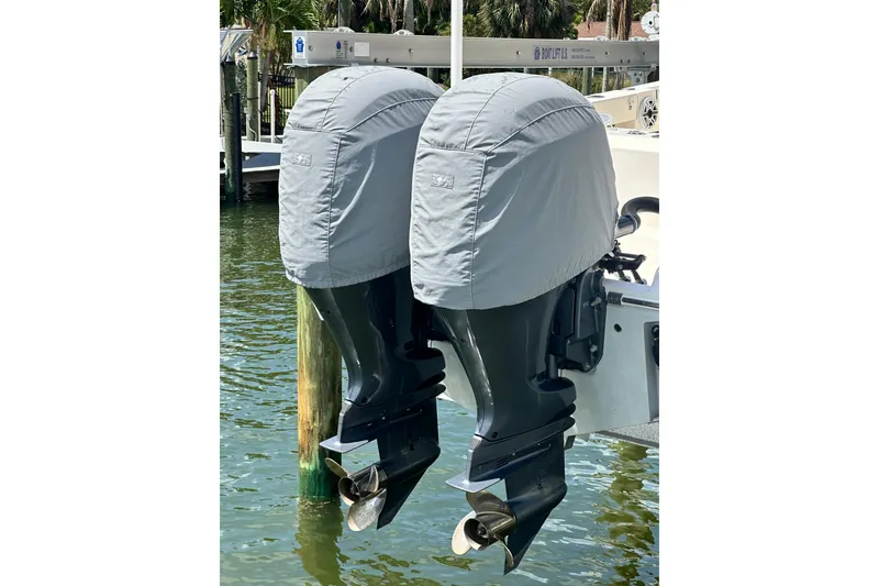 Slide: The Image of Twin outboard motors on a 2021 Cobia 240 Center Console, covered and docked. - 7