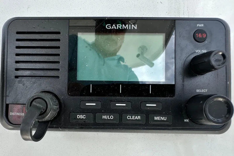 Slide: The Image of Garmin marine radio on 2021 Cobia 240 Center Console boat dashboard. - 74