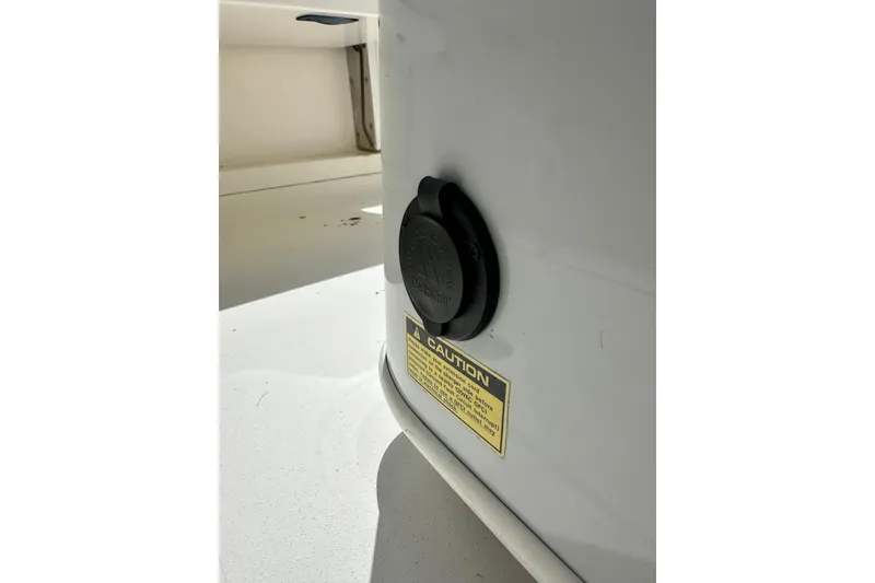 Slide: The Image of 2021 Cobia 240 Center Console boat detail with caution label and black cap. - 79