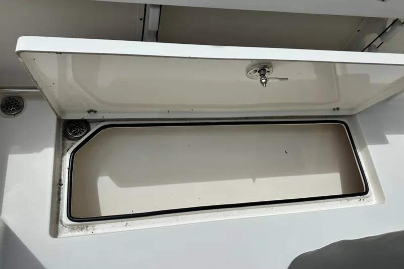 Slide: The Image of Open storage compartment on a 2021 Cobia 240 Center Console boat. - 89