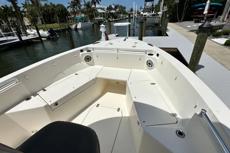Slide: The Image of 2021 Cobia 240 Center Console boat docked, featuring spacious seating and storage compartments. - 9