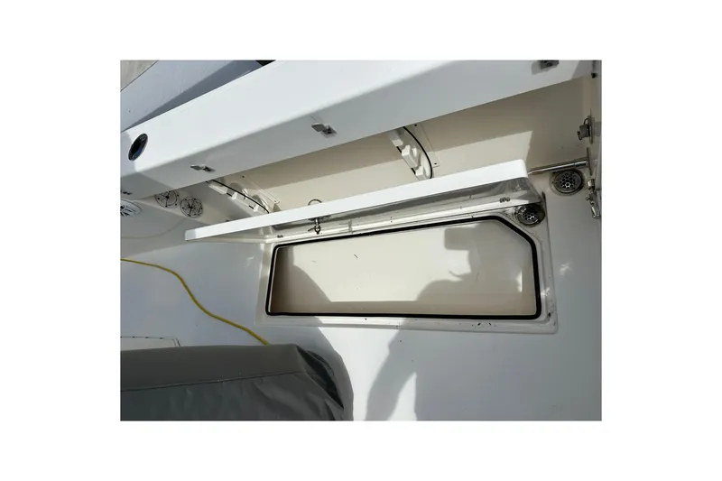 Slide: The Image of 2021 Cobia 240 Center Console boat storage compartment, open and empty. - 90