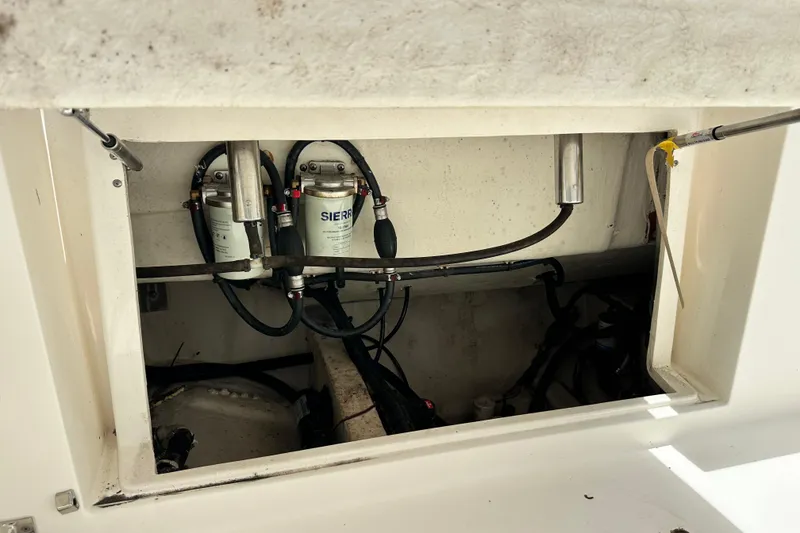 Slide: The Image of 2021 Cobia 240 Center Console fuel system components in an open compartment. - 94