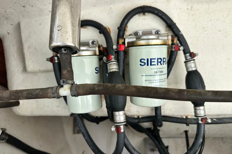 Slide: The Image of Fuel filters and hoses in a 2021 Cobia 240 Center Console boat. - 95