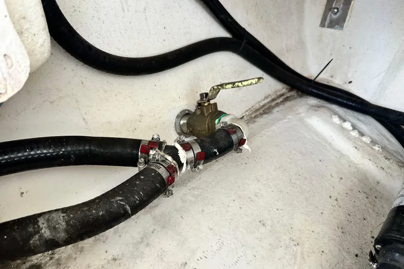 Slide: The Image of Bilge area of 2021 Cobia 240 Center Console with hoses and valve. - 97