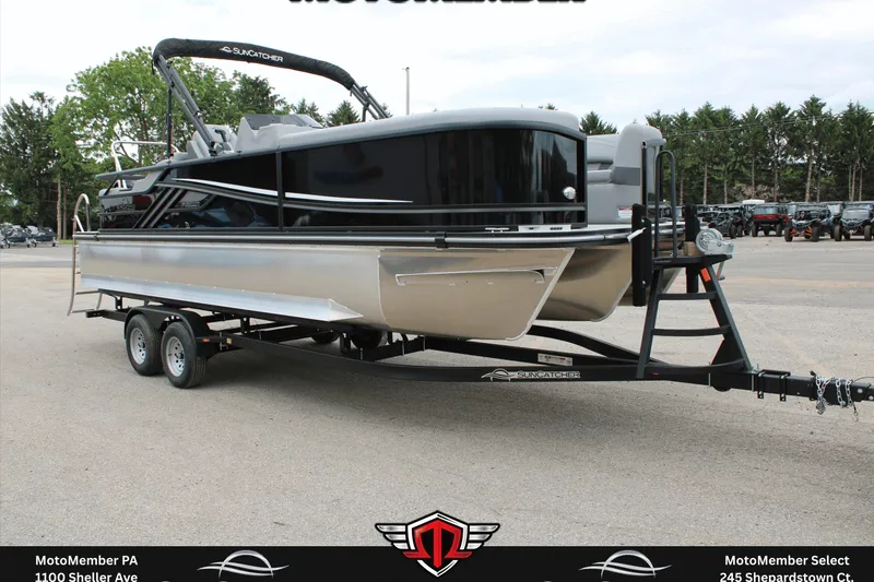 The Image of 2026 SunCatcher Fusion 324SS pontoon boat on trailer, parked outdoors. - 0